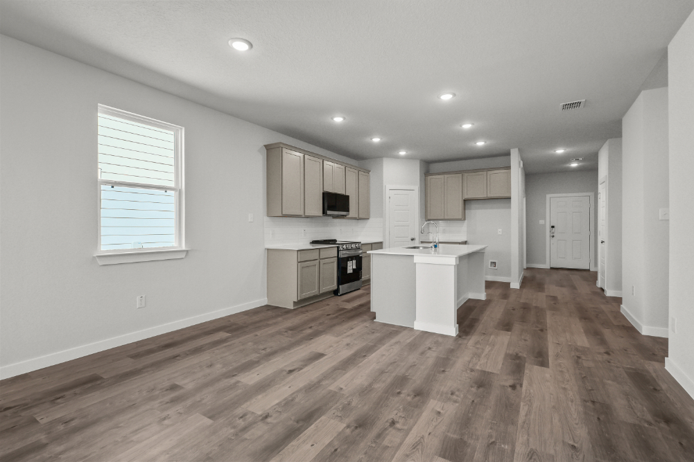 A kitchen with white cabinets.