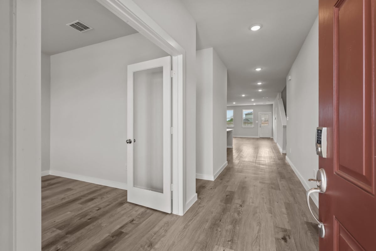 A hallway with white doors.
