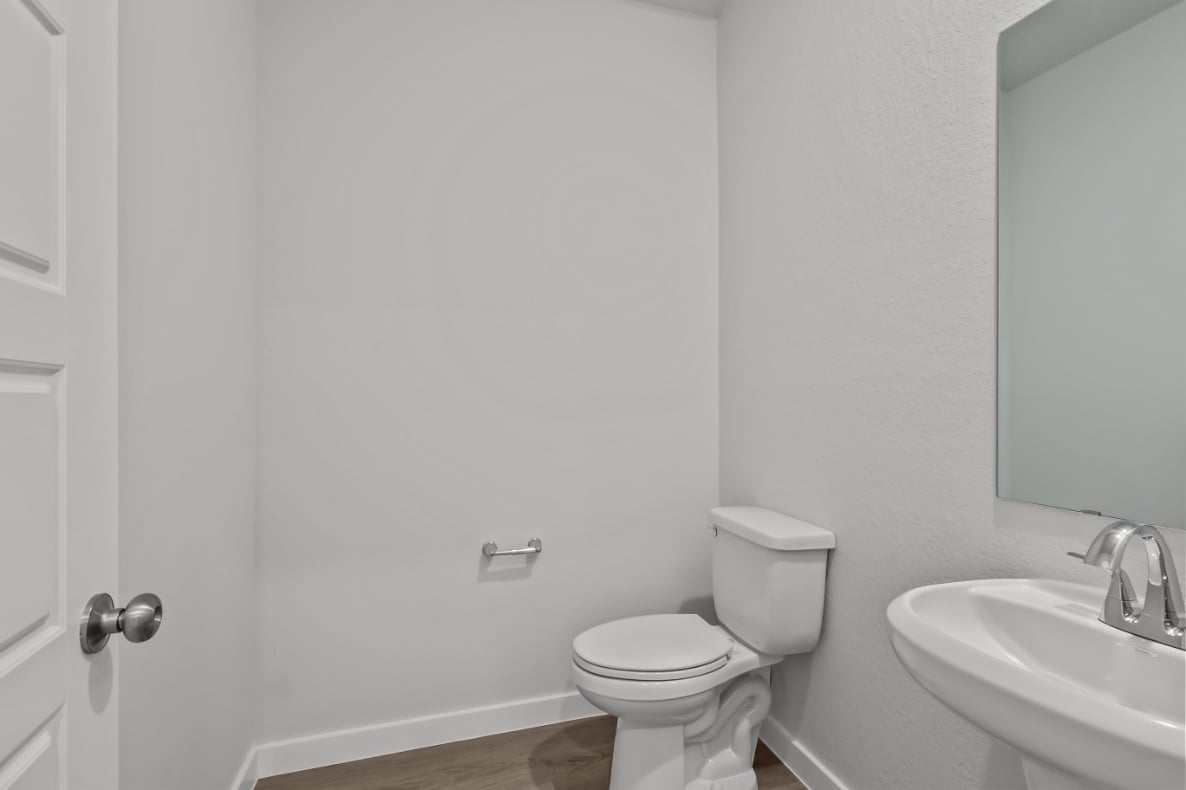 A bathroom with a toilet and sink.