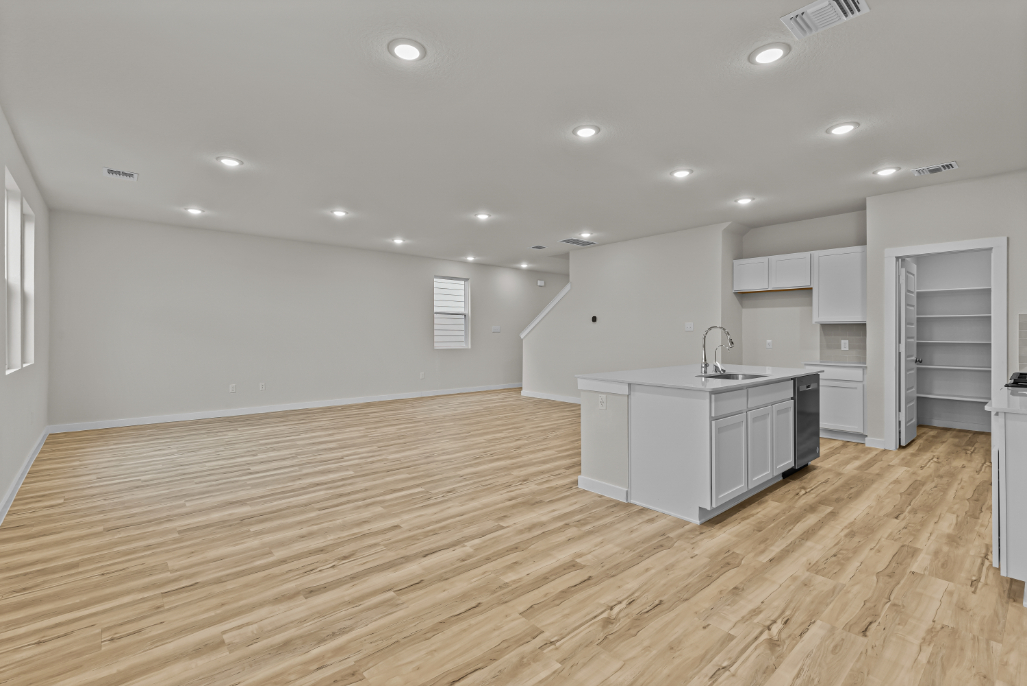 A kitchen with white cabinets.