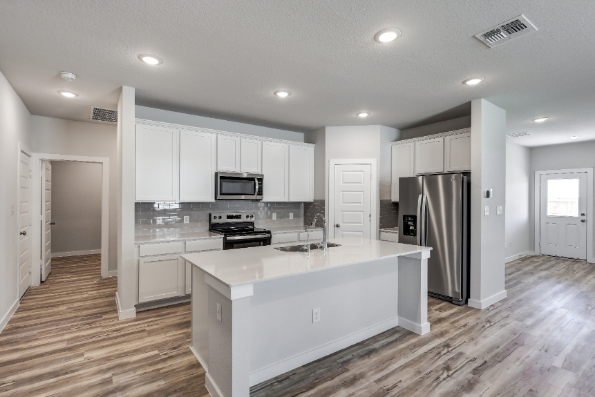 A kitchen with white cabinets.