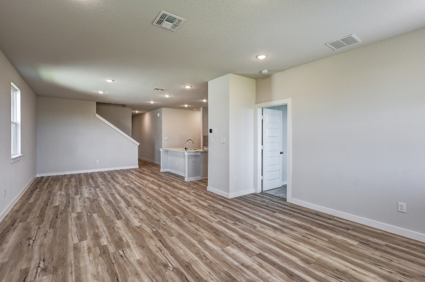 A room with a wood floor and white walls.