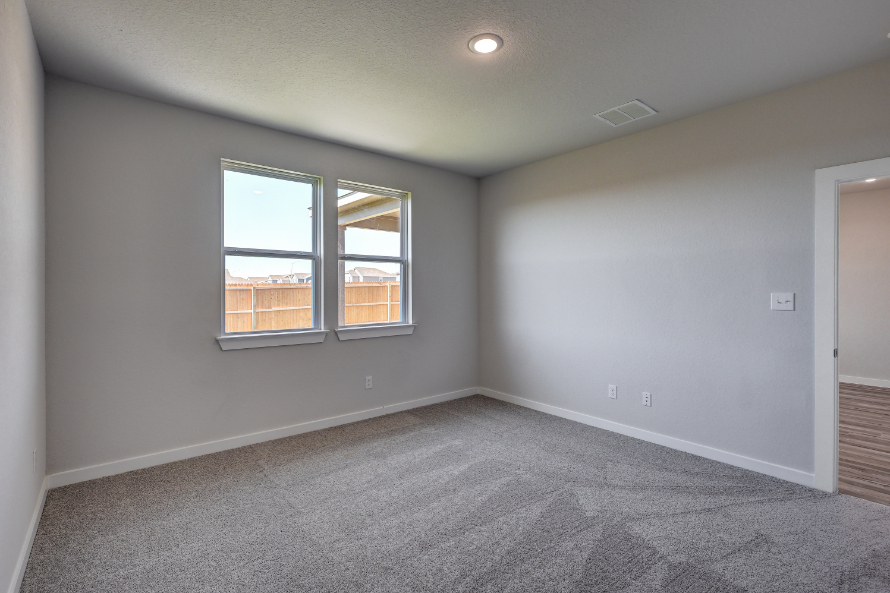 A room with a window and a carpet.