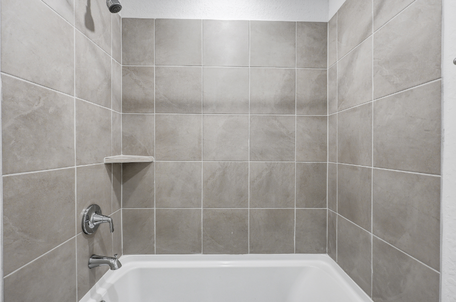 A bathtub in a bathroom.