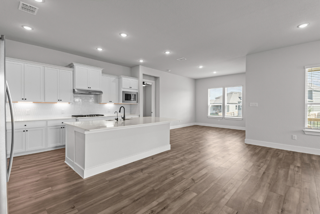A kitchen with white cabinets.