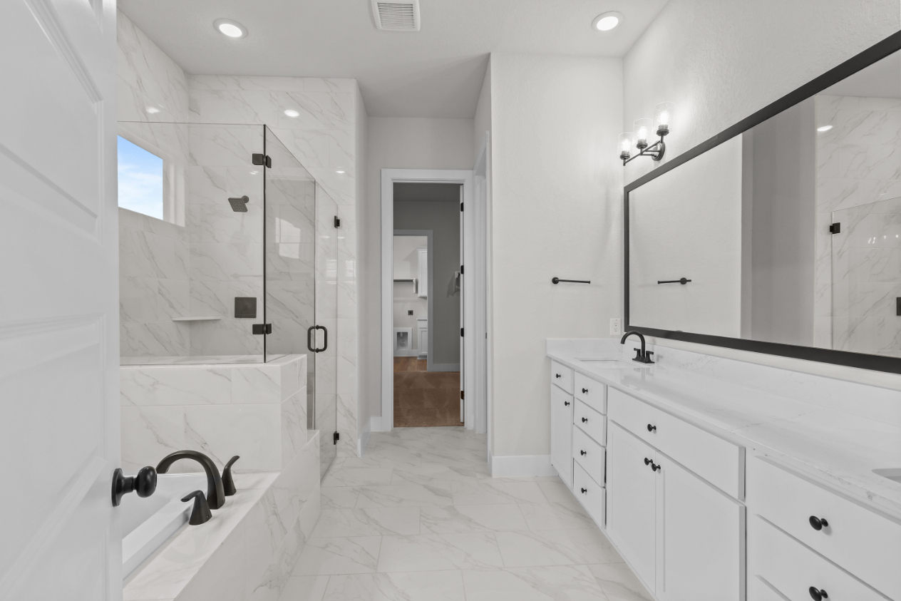 A bathroom with a large mirror.