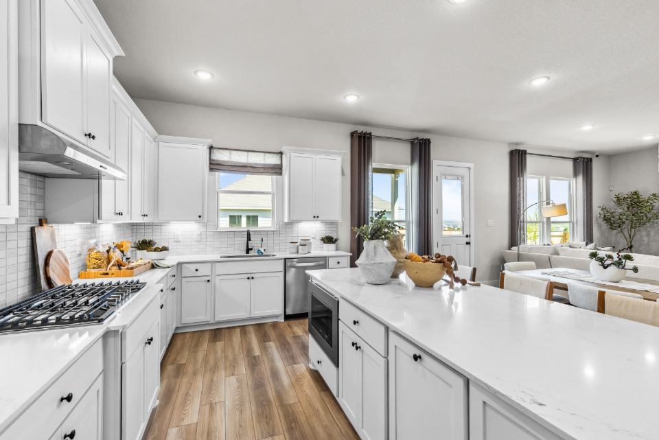 A kitchen with white cabinets.