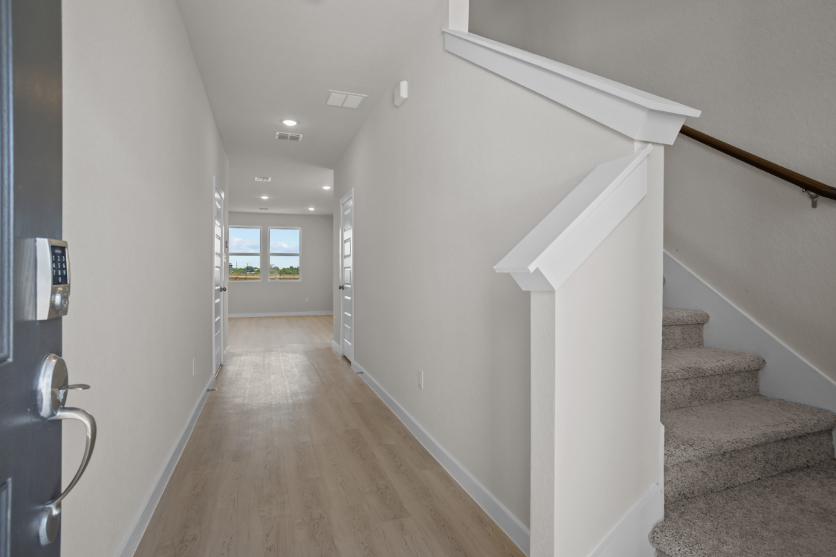 A hallway with white walls.