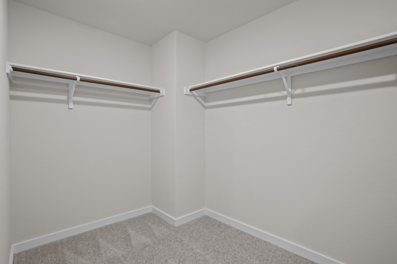A white wall with a white floor and a carpet.