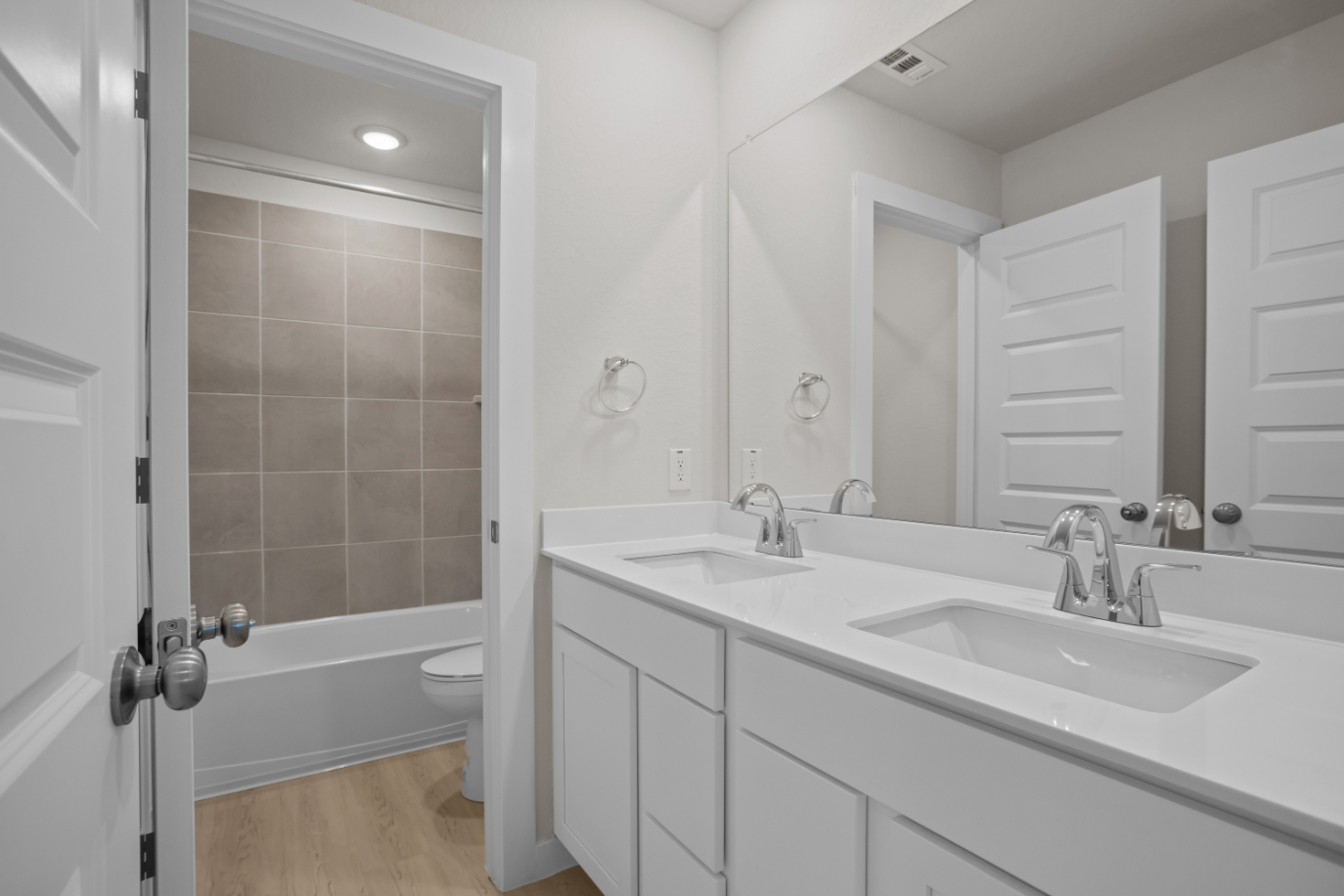 A bathroom with a tub sink and toilet.