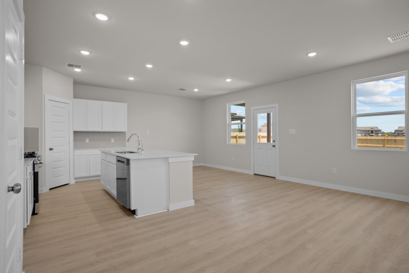 A kitchen with white cabinets.