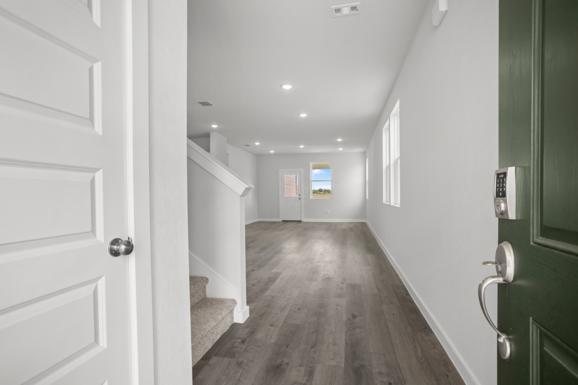 A hallway with green doors.