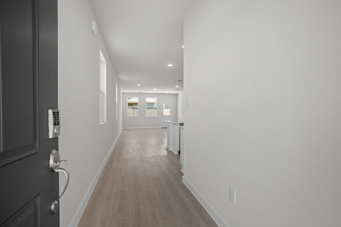 A hallway with white walls.