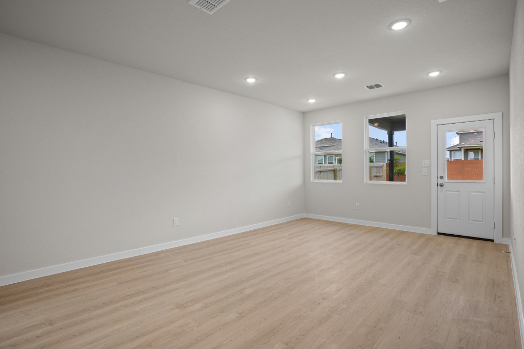 A room with a wood floor and white walls.