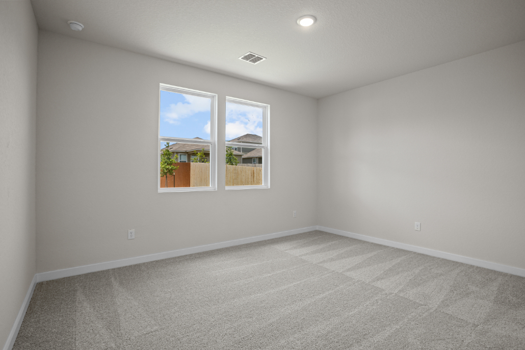A room with a window and a tile floor.