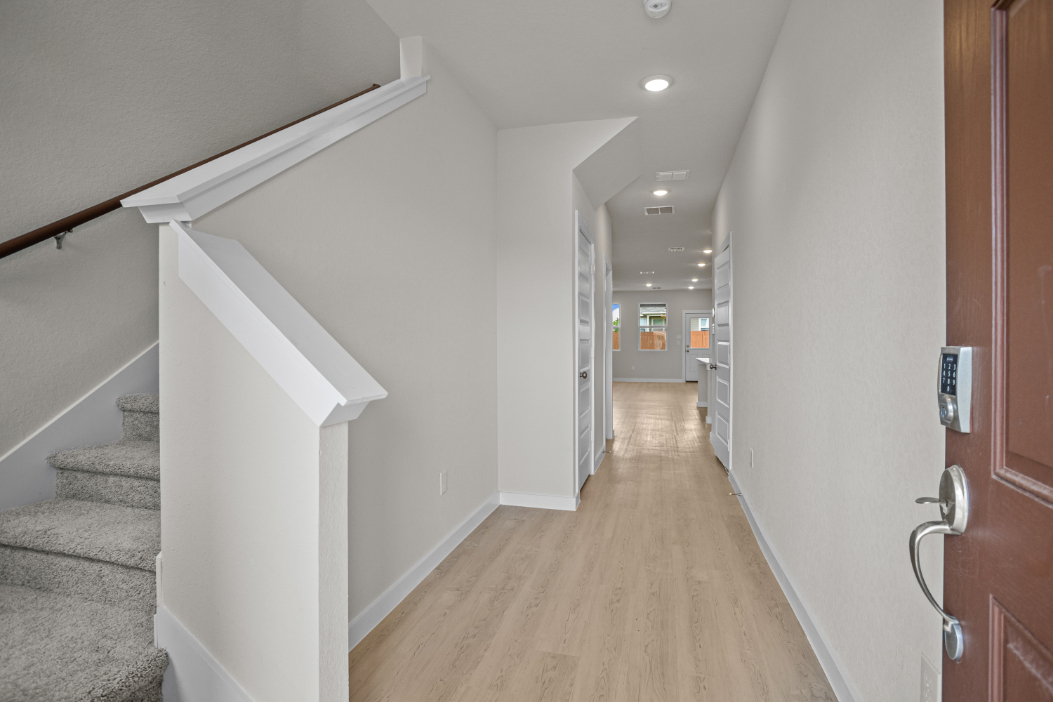 A hallway with white walls.