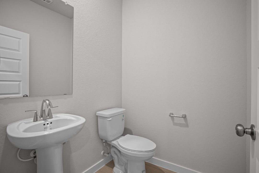 A bathroom with a toilet and sink.