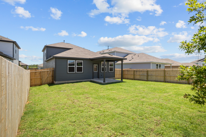 A house with a fence and grass.