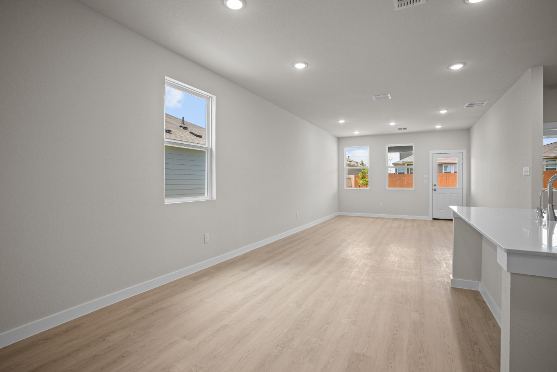 A room with a wood floor and white walls.