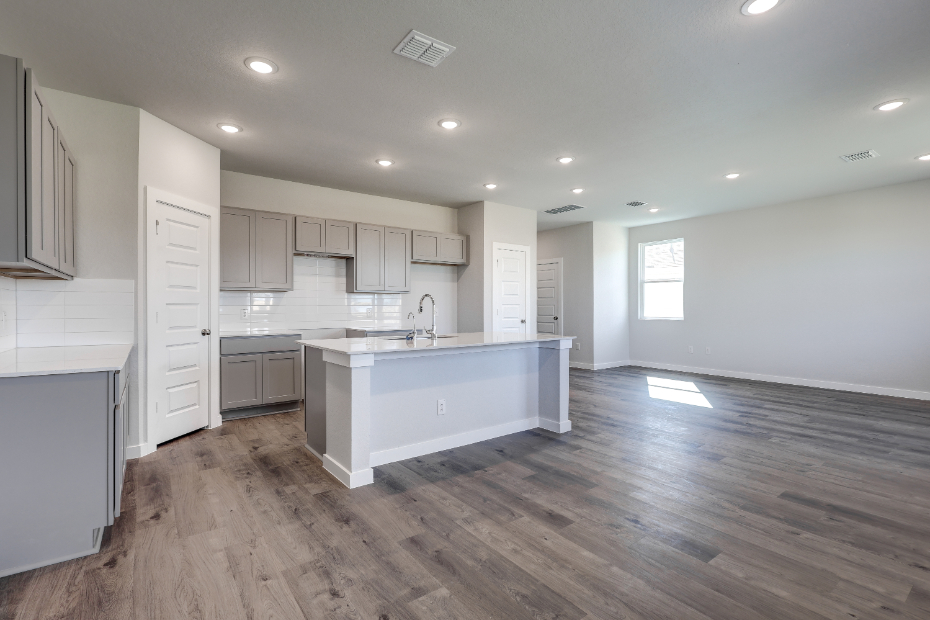 A kitchen with white cabinets.
