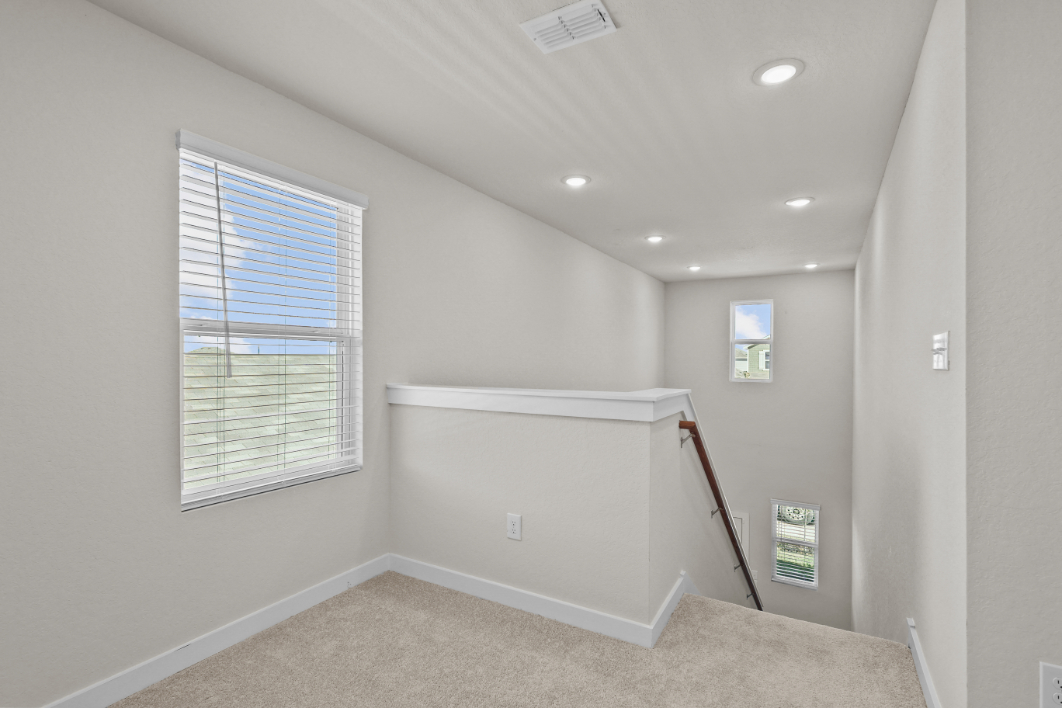 A room with a window and a ladder.