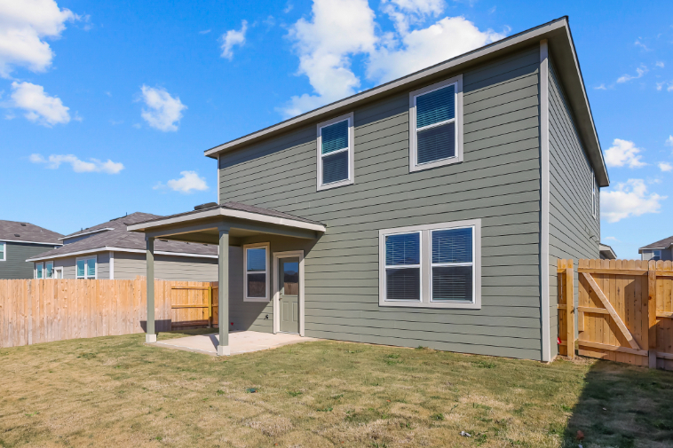 A house with a fence and grass.