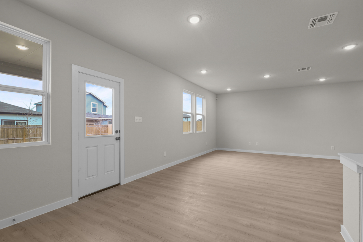 A room with a wood floor and a white door.