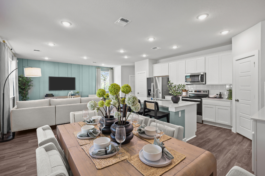 A kitchen with a table and chairs.