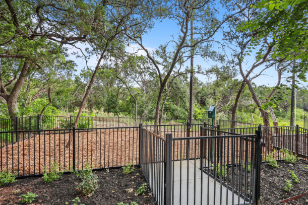 A fenced in area with trees.