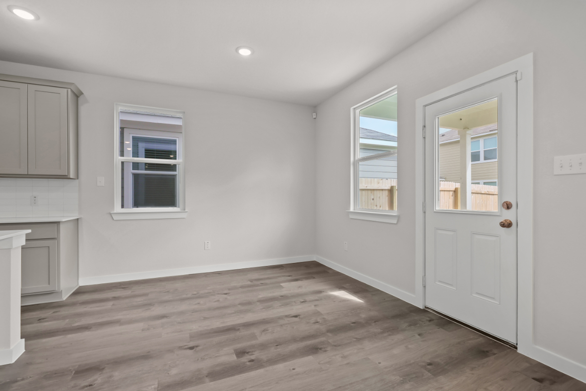 A room with white walls and a wood floor.