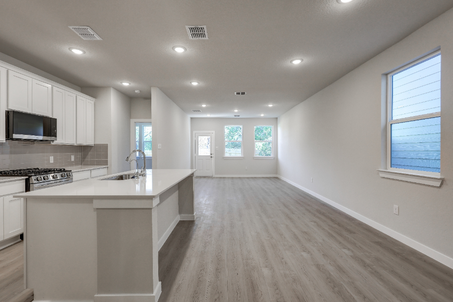A kitchen with white cabinets.