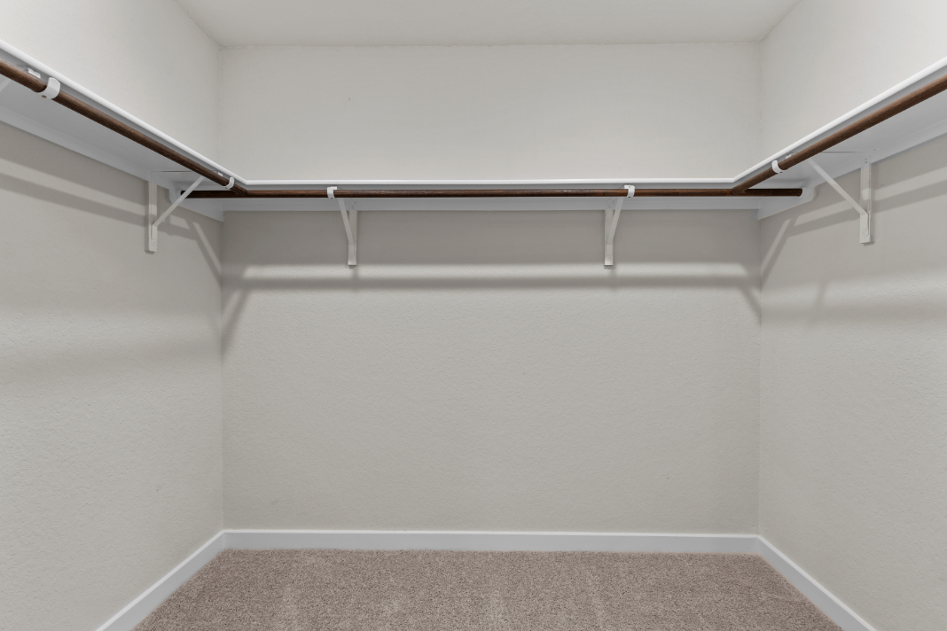 A white wall with a metal railing.