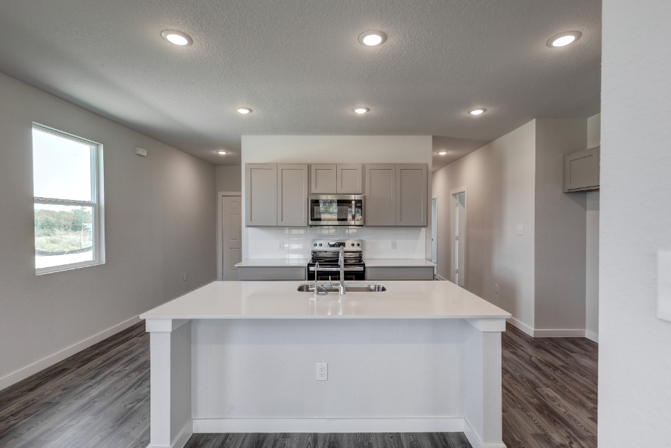A kitchen with white cabinets.