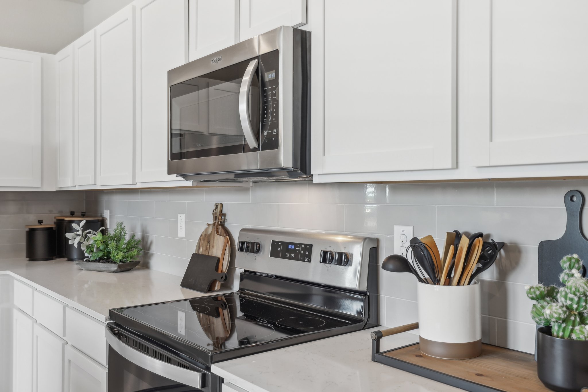 A kitchen with white cabinets.
