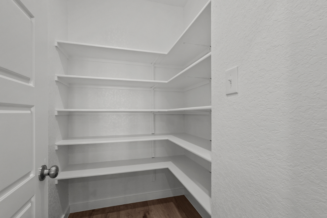 A white staircase with white walls.