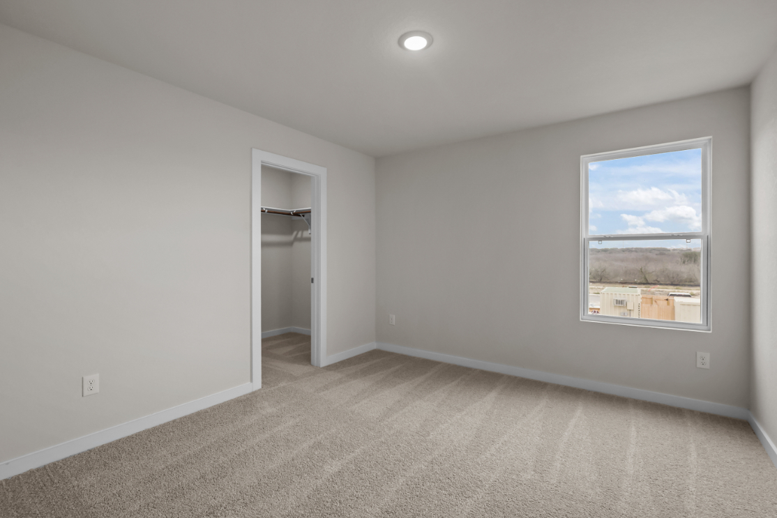 A room with a window and a door.