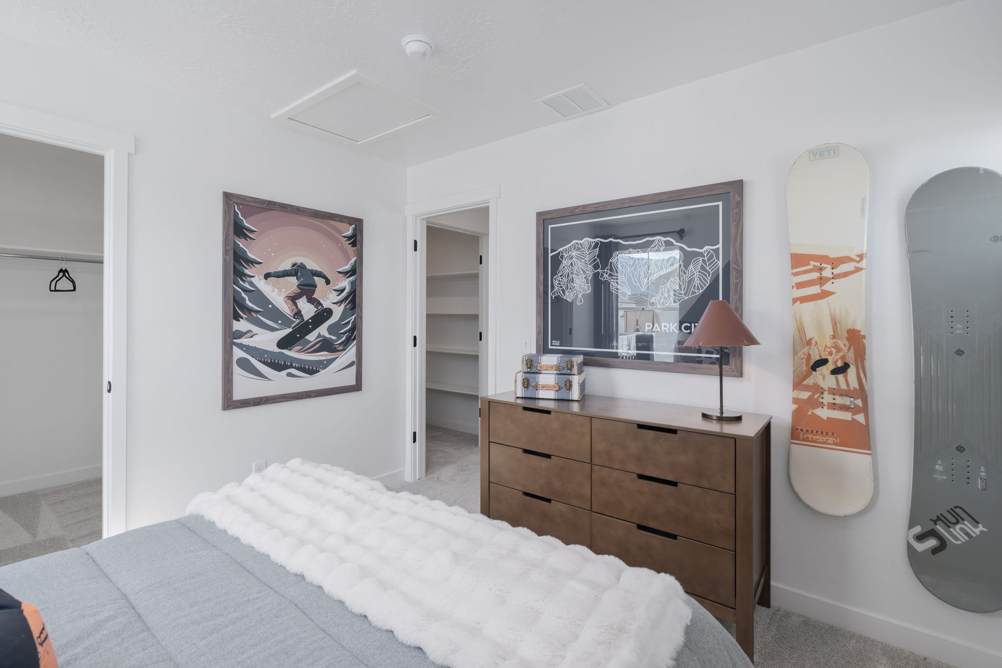 A bedroom with a bed and a dresser.