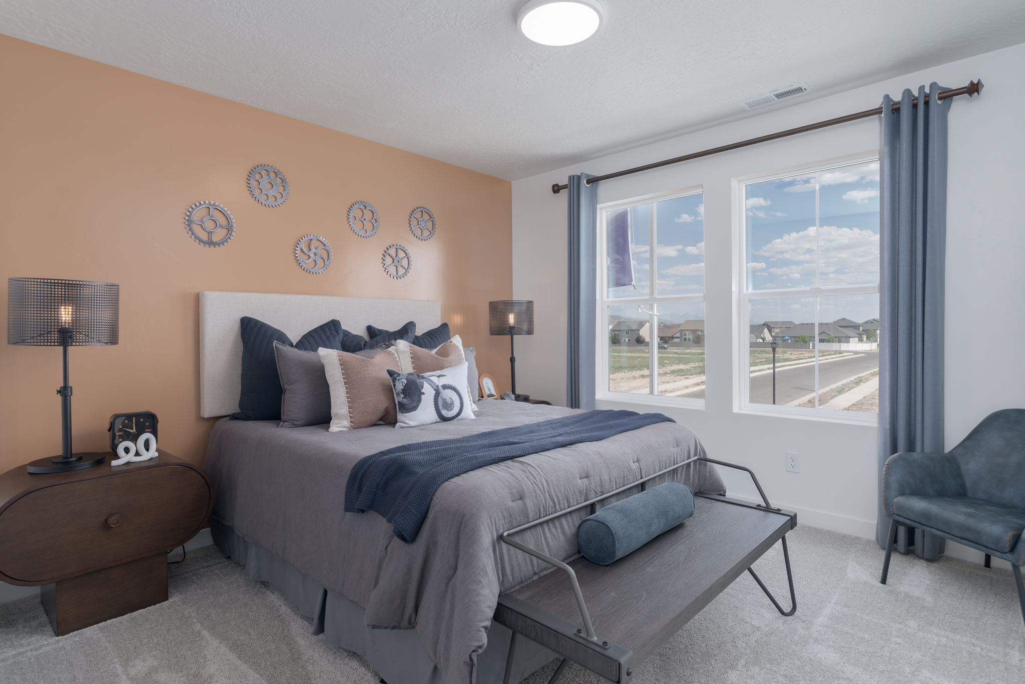 A bedroom with a bed and a bench.