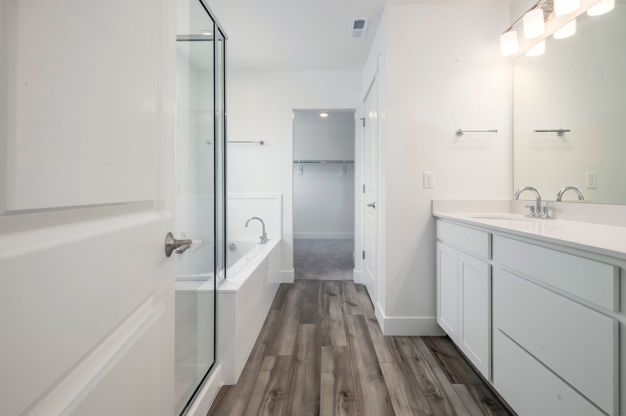 A bathroom with white cabinets.
