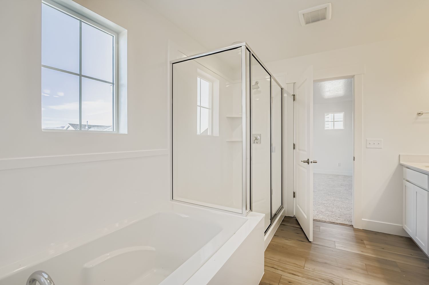 A bathroom with a tub and a window.