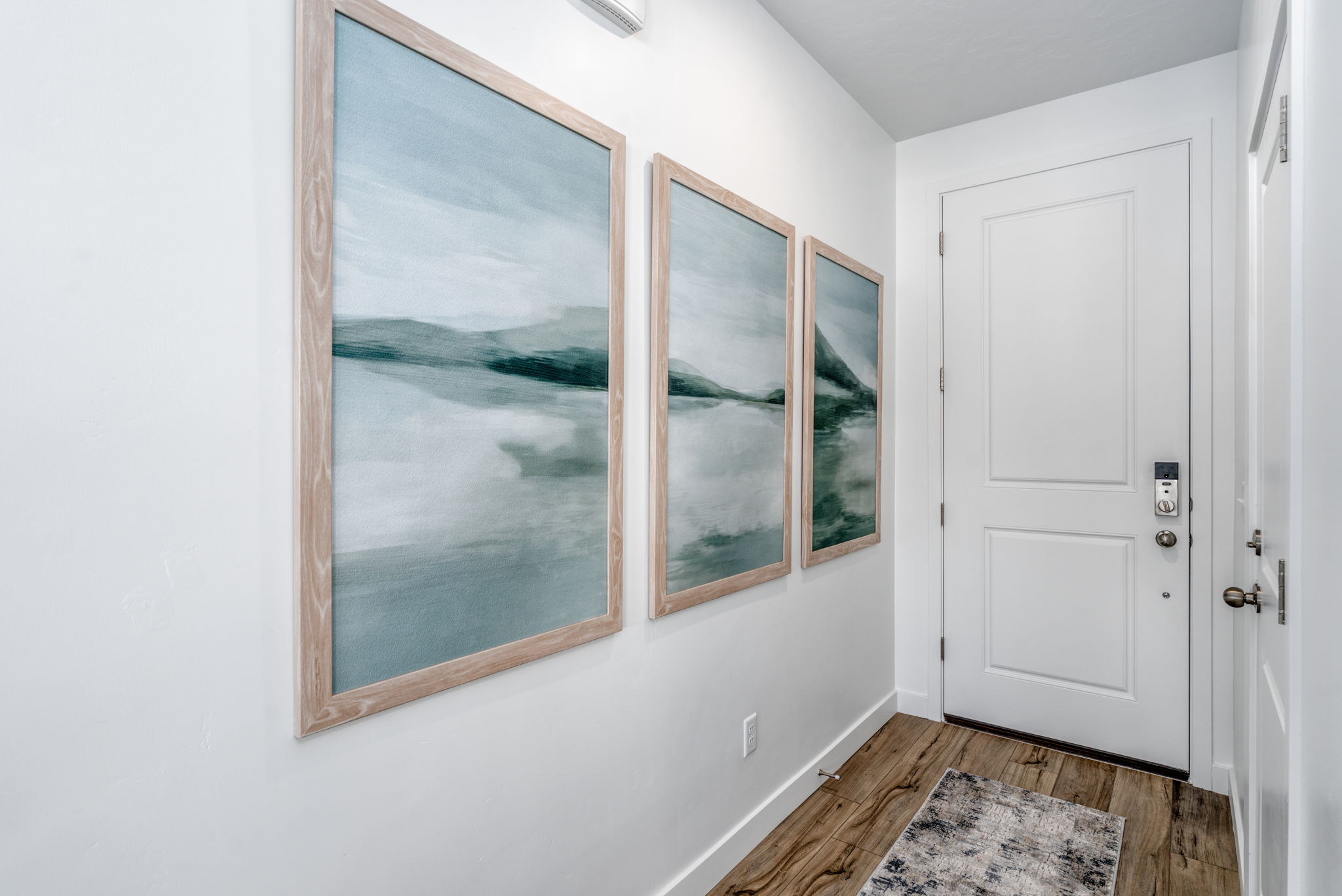 A room with a window and a rug.