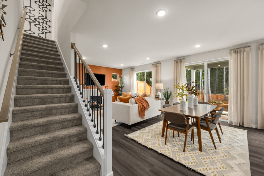 A large living room with a staircase.