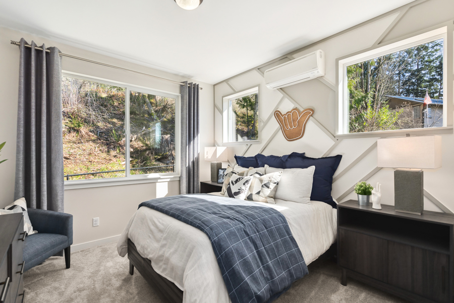 A bedroom with a bed and a window.