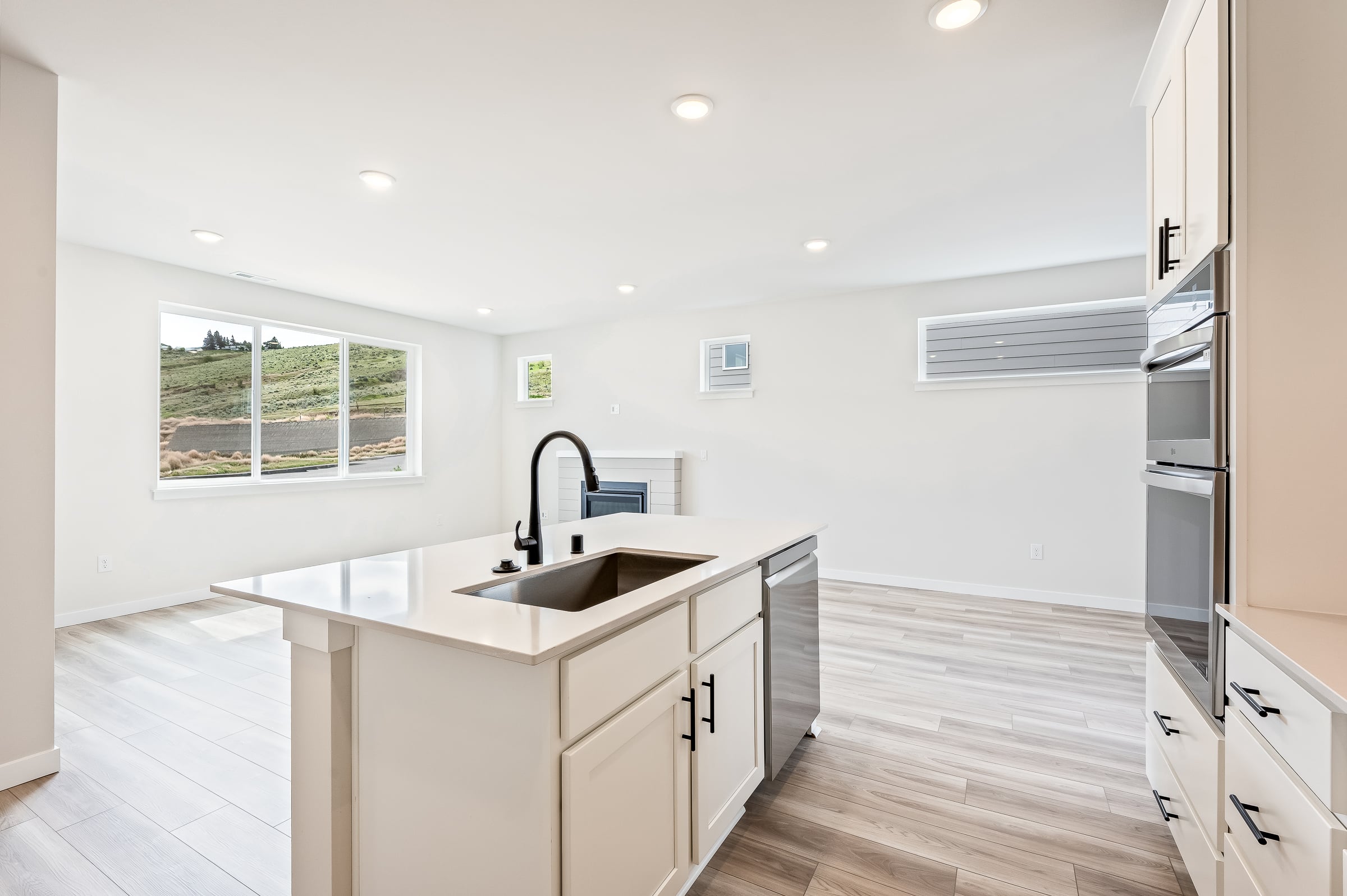 A kitchen with white cabinets.