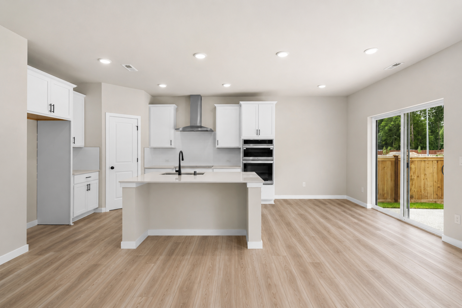 A kitchen with white cabinets.
