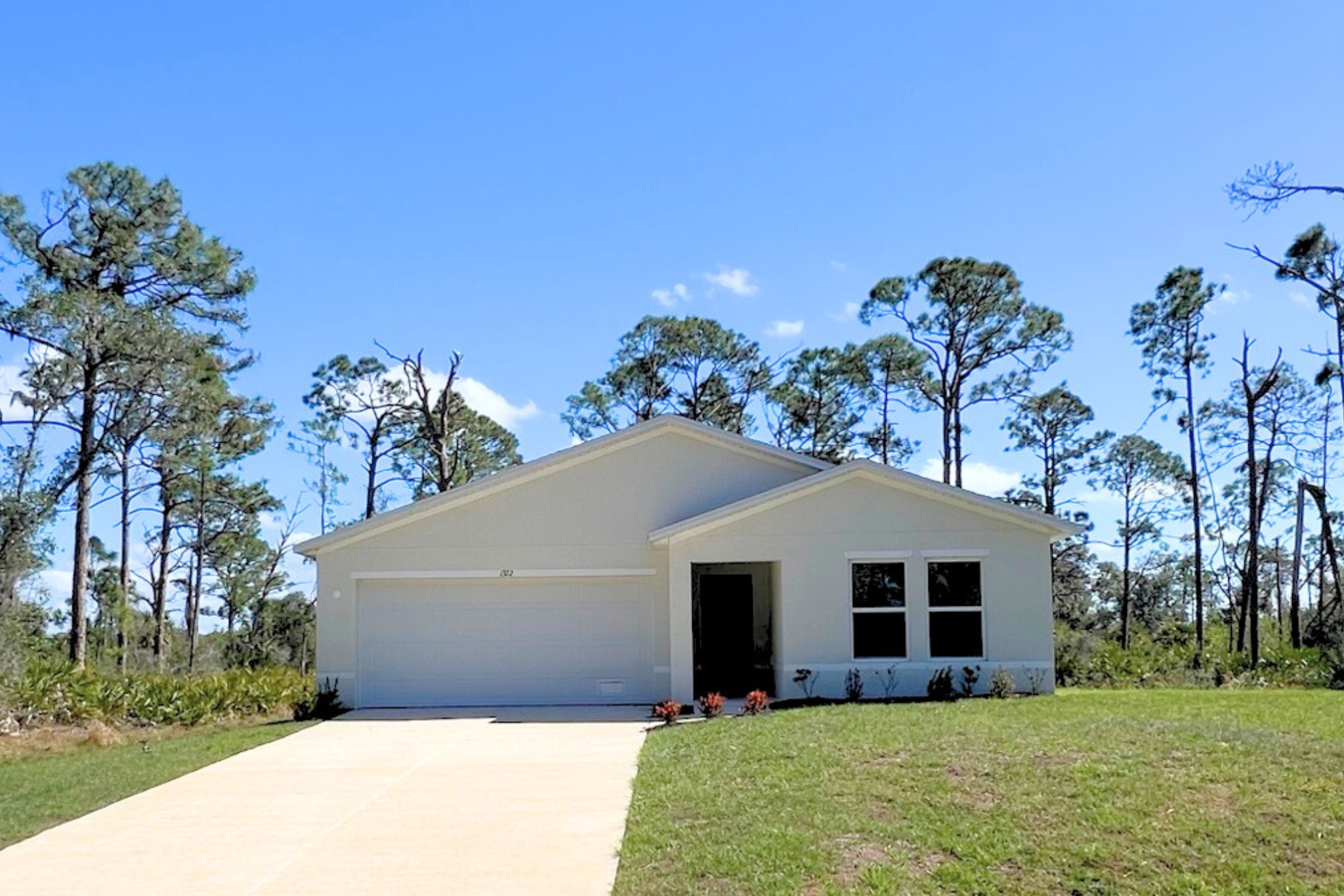 A house with a driveway and grass.
