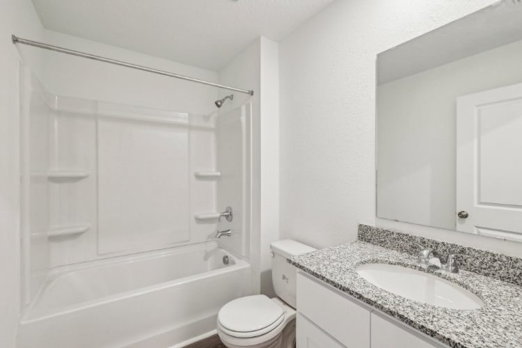 A bathroom with a sink toilet and bathtub.