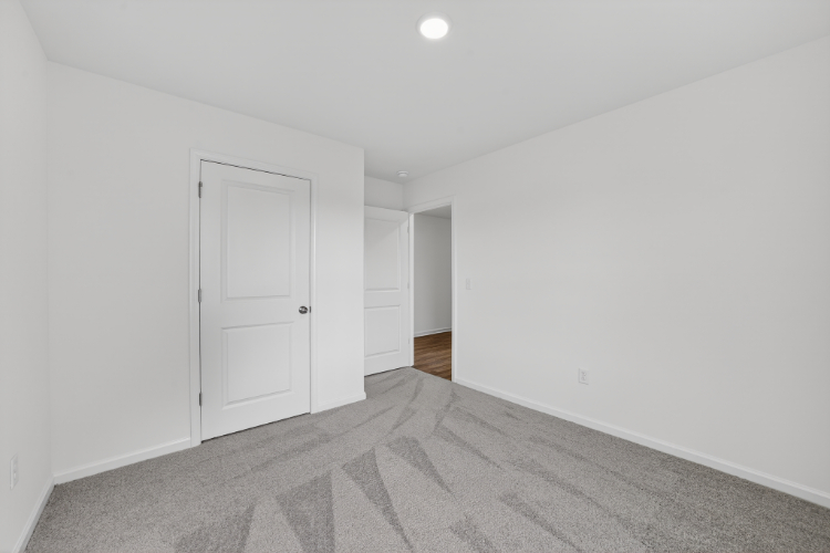 A hallway with white doors.