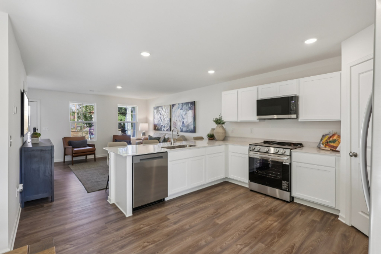 A kitchen with white cabinets.
