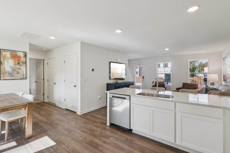 A kitchen with white cabinets.
